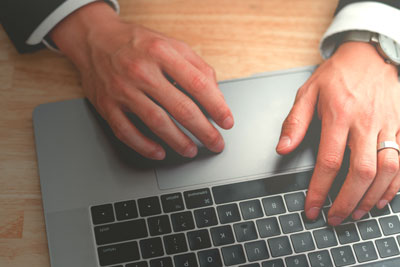 hands on the keyboard of a laptop computer