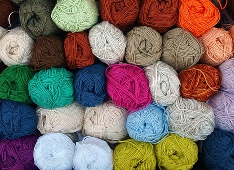 stack of skeins of yarn in many colors