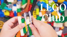 A scattering of different colors of LEGO bricks with kids hands putting LEGOs together.