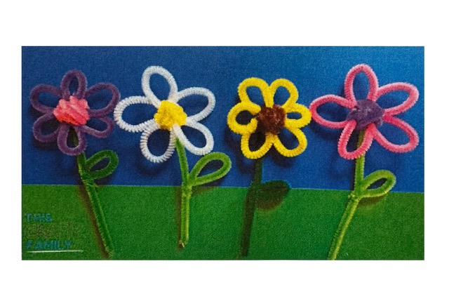 4 colorful flowers made from twisted pipe cleaners.