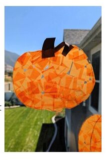 Pumpkin Craft Torn paper pieces are collaged onto a paper in the form of a pumpkin.
